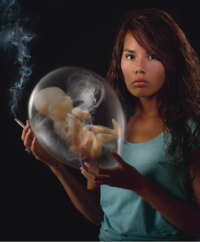 woman holding a filled balloon with a fetus inside